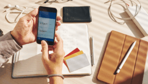 personne qui regarde son compte en banque avec son téléphone